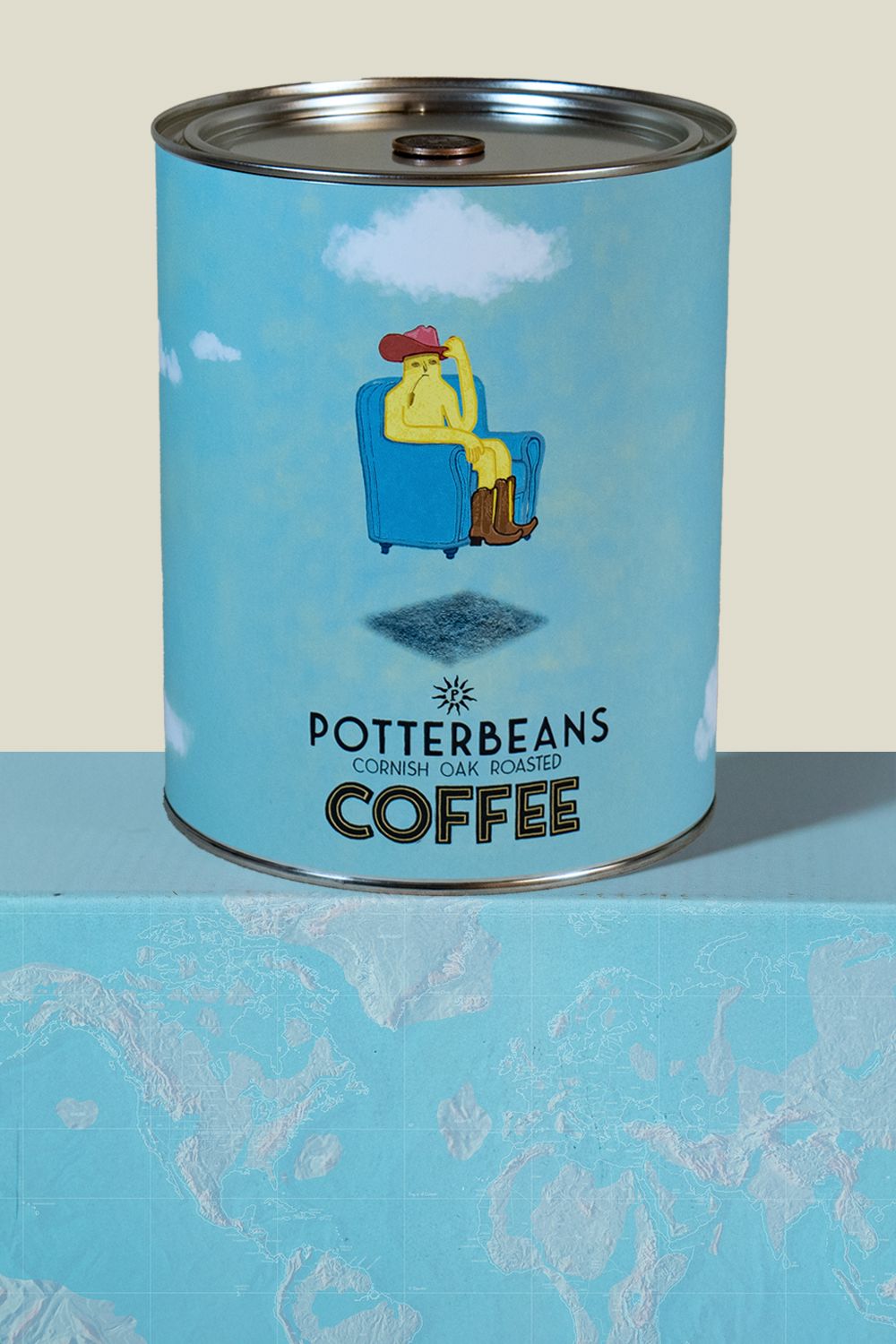 Can of Potterbeans Colombian coffee with a graphic of a person in a chair on a blue background