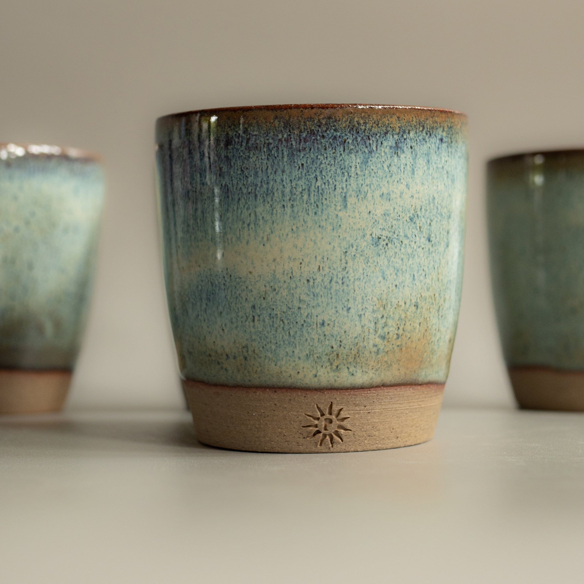 Stoneware clay, hand thrown espresso cup in waters edge glaze