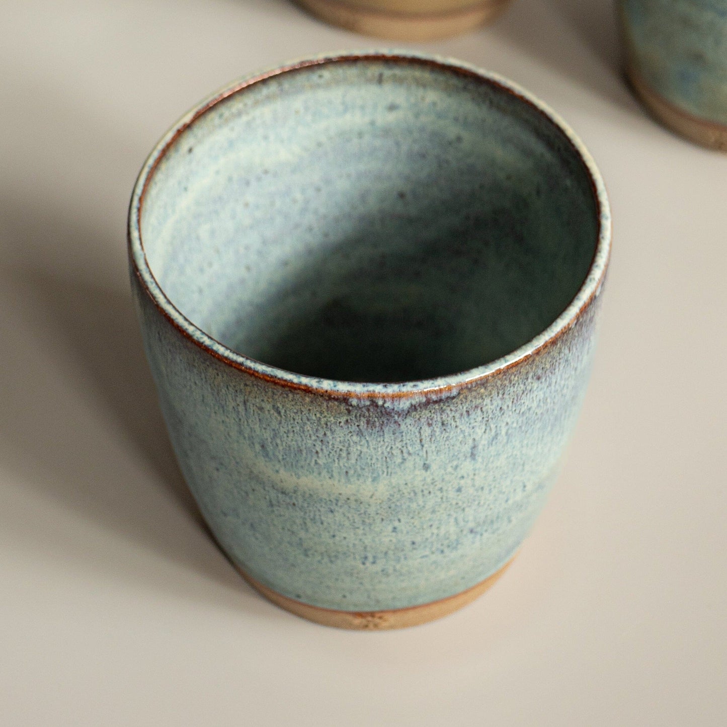hand thrown toasted stoneware clay coffee cup.