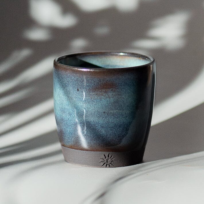 Glazed in floating turquoise blue, thrown in black stoneware clay. Espresso cups.
